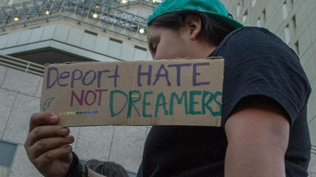 A supporter marches past the Metropolitan Detention Center as undocumented people jailed inside tap on the windows in opposition to US President Donald Trump’s order end to DACA on September 5.(AFP Photo) A supporter marches past the Metropolitan Detention Center as undocumented people jailed inside tap on the windows in opposition to US President Donald Trump’s order end to DACA on September 5.(AFP Photo)