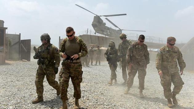 U.S. Army soldiers walk as a NATO helicopter flies overhead at coalition force Forward Operating Base (FOB) Connelly in the Khogyani district in the eastern province of Nangarhar on August 13, 2015.(AFP/Getty Images Files)