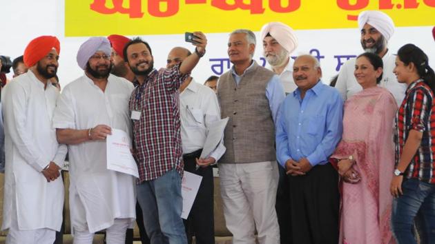 A man who was received a job letter takes a selfie with Punjab CM Capt Amarinder Singh and technical education minister Charanjit Singh Channi in Mohali on Tuesday.