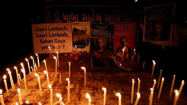 Candles are kept in front of photos of Gauri Lankesh, who according to police was shot dead outside her home on Tuesday.(REUTERS)