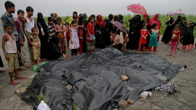 Bangladeshi villagers gather around bodies of Rohingya women and children at Shah Porir Deep, in Teknak, Bangladesh, after a capsizing accident. Refugees have been fleeing, aided by smugglers charging about 10,000 Myanmar kyat (approx ₹500) for each person in the family to be ferried across the rivers adjoining Bangladesh and Myanmar in rickety wooden boats. (Suvra Kanti Das / AP) Bangladeshi villagers gather around bodies of Rohingya women and children at Shah Porir Deep, in Teknak, Bangladesh, after a capsizing accident. Refugees have been fleeing, aided by smugglers charging about 10,000 Myanmar kyat (approx ₹500) for each person in the family to be ferried across the rivers adjoining Bangladesh and Myanmar in rickety wooden boats. (Suvra Kanti Das / AP)