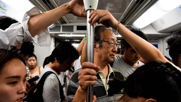 Yao, 72, a member of ‘Old Jazz Band’ heads back home in a metro ahead of his performance at Shanghai's ornate Fairmont Peace Hotel in Shanghai.The bar where the ‘Old Jazz Band’ now plays 365 nights of the year was originally an English-style pub and it retains that flavour with its bar stools, dark-wooden fittings and a musty feel. (Chandan Khanna / AFP) Yao, 72, a member of ‘Old Jazz Band’ heads back home in a metro ahead of his performance at Shanghai's ornate Fairmont Peace Hotel in Shanghai.The bar where the ‘Old Jazz Band’ now plays 365 nights of the year was originally an English-style pub and it retains that flavour with its bar stools, dark-wooden fittings and a musty feel. (Chandan Khanna / AFP)