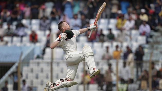 Australia's David Warner jumps in the air in celebration after scoring his 20th hundred against Bangladesh in Chittagong.(AP)