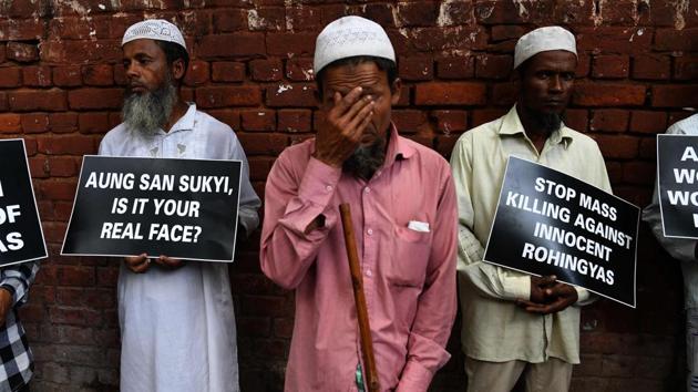 Rohingya Muslim refugees hold placards against human rights violations in Myanmar during a protest in New Delhi on September 5, 2017. Aung San Suu Kyi, Myanmar’s state councillor and de facto leader has also drawn criticism from fellow Nobel Peace Prize laureate Malala Yousafzai, who decried the treatment of the Rohingyas as ‘tragic and shameful’. Yousafzai also called upon Myanmar to recognize the Rohingya’s right to citizenship and called upon other nations to aid in their refuge. (Prakash Singh / AFP) Rohingya Muslim refugees hold placards against human rights violations in Myanmar during a protest in New Delhi on September 5, 2017. Aung San Suu Kyi, Myanmar’s state councillor and de facto leader has also drawn criticism from fellow Nobel Peace Prize laureate Malala Yousafzai, who decried the treatment of the Rohingyas as ‘tragic and shameful’. Yousafzai also called upon Myanmar to recognize the Rohingya’s right to citizenship and called upon other nations to aid in their refuge. (Prakash Singh / AFP)