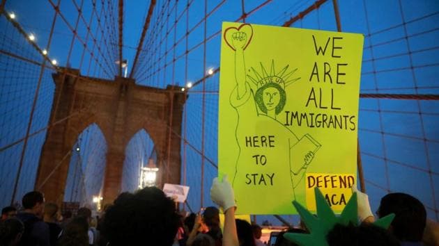 People march across the Brooklyn Bridge to protest the planned dissolution of DACA in Manhattan, New York City on Tuesday.(Reuters)
