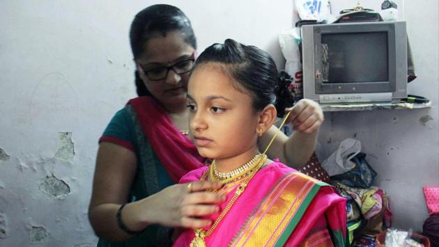 Vainavi preps up at home before leaving for Vasai to perform with her fellow drummers. She is currently studying in 5th standard and plays Dhol for the group, ‘Swargandhar.’ (Pramod Thakur/HT PHOTO) Vainavi preps up at home before leaving for Vasai to perform with her fellow drummers. She is currently studying in 5th standard and plays Dhol for the group, ‘Swargandhar.’ (Pramod Thakur/HT PHOTO)