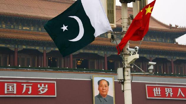 A Pakistan national flag flies alongside a Chinese national flag in front of the portrait of Chairman Mao Zedong on Beijing's Tiananmen Square.(REUTERS File Photo)