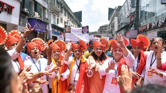 Women dance during Ganesh visarjan wearing traditional Maharashtrian turban (pheta) in Pune on Tuesday.  (Pratham Gokhale/HT PHOTO) 