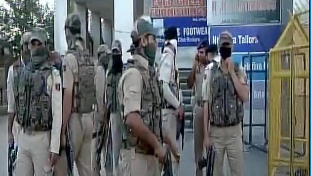 Securitymen take position after a grenade blast in Srinagar on Thursday.(ANI Photo/Twitter)