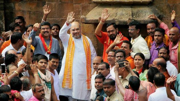 BJP national president Amit Shah, minister for petroleum and natural gas Dharmendra Pradhan & BJP State President Basanta Panda wave to supporters during a visit to Lord Lingaraj Temple in Bhubaneswar on Thursday. (PTI Photo) BJP national president Amit Shah, minister for petroleum and natural gas Dharmendra Pradhan & BJP State President Basanta Panda wave to supporters during a visit to Lord Lingaraj Temple in Bhubaneswar on Thursday. (PTI Photo)