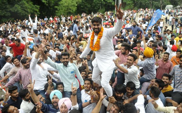 Vikas of DAV College, Sector 10, celebrating with his supporters after he was elected as the president. (Karun sharma/HT)