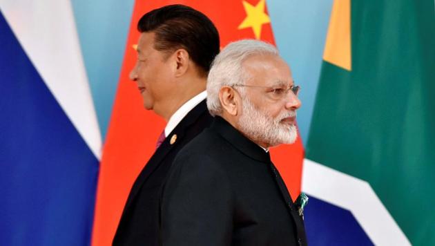 Chinese president Xi Jinping (left) and Prime Minister Narendra Modi at the group photo session during the BRICS Summit at the Xiamen International Conference and Exhibition Center in Xiamen, China, on September 4, 2017. (Reuters File Photo) Chinese president Xi Jinping (left) and Prime Minister Narendra Modi at the group photo session during the BRICS Summit at the Xiamen International Conference and Exhibition Center in Xiamen, China, on September 4, 2017. (Reuters File Photo)