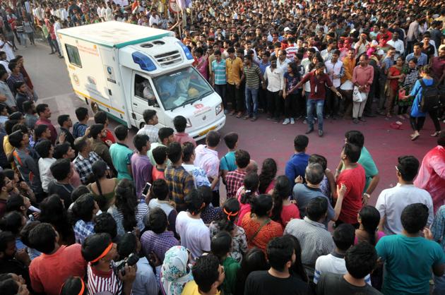 Volunteers and devotees make way for an ambulance during Ganesh visarjan procession at Tilak chowk on Tuesday in Pune. (HT Photo) 