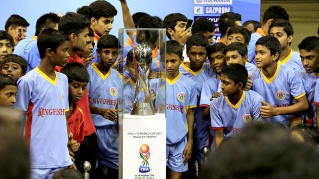 Indian children look at the FIFA U-17 World Cup trophy during its unveiling for public viewing in Kolkata.(AP)