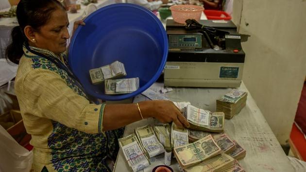 CASH COUNTER: A member puts away the bundles. (Kunal Patil/HT Photo) 