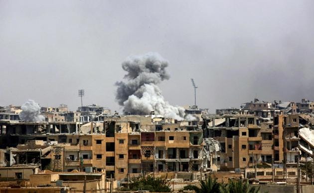 A picture taken on September 5, 2017 shows smoke billowing out following a coalition air strike in the western al-Daraiya neighbourhood of the embattled northern Syrian city of Raqa.(AFP File Photo)