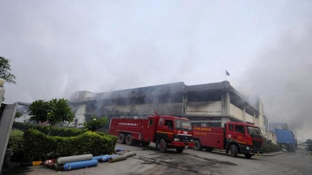 moke billowing out of the Haldiram’s unit after 18 hours from the time it went up in flames. (Sunil Ghosh/HT Photo) moke billowing out of the Haldiram’s unit after 18 hours from the time it went up in flames. (Sunil Ghosh/HT Photo)