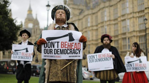 Protesters dressed in Tudor costumes, including one dressed as King Henry VIII, hold signs protesting elements of the European Union Withdrawal Bill that is being debated by lawmakers in the House of Commons in London on September 7, 2017. British lawmakers have begun debating the landmark bill to end Britain's membership of the European Union, with Prime Minister Theresa May gearing up for a major battle. (AFP) Protesters dressed in Tudor costumes, including one dressed as King Henry VIII, hold signs protesting elements of the European Union Withdrawal Bill that is being debated by lawmakers in the House of Commons in London on September 7, 2017. British lawmakers have begun debating the landmark bill to end Britain's membership of the European Union, with Prime Minister Theresa May gearing up for a major battle. (AFP)
