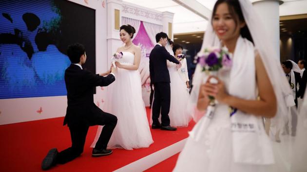 Tying the knot in the mass wedding was more meaningful as everyone in the hall was family to them, she added. ‘Everyone is also brother and sister,’ she said. It ‘makes everything more memorable and precious because all of us are sharing this precious moment together centering upon our heavenly parents’. (Kim Hong-Ji / REUTERS) Tying the knot in the mass wedding was more meaningful as everyone in the hall was family to them, she added. ‘Everyone is also brother and sister,’ she said. It ‘makes everything more memorable and precious because all of us are sharing this precious moment together centering upon our heavenly parents’. (Kim Hong-Ji / REUTERS)