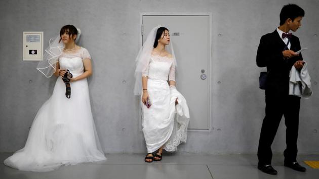 A groom and brides wait for their partners before the mass wedding ceremony. In recent years, matchmaking responsibilities have shifted towards parents and the emergence of social media has made it easier for brides and grooms to ‘connect’ before their wedding. Vanessa from Singapore was introduced to her groom Ewald Schenkermayr, a 30-year-old from Austria, by her parents and kept in touch through emails and Skype conversations. (Kim Hong-Ji / REUTERS) A groom and brides wait for their partners before the mass wedding ceremony. In recent years, matchmaking responsibilities have shifted towards parents and the emergence of social media has made it easier for brides and grooms to ‘connect’ before their wedding. Vanessa from Singapore was introduced to her groom Ewald Schenkermayr, a 30-year-old from Austria, by her parents and kept in touch through emails and Skype conversations. (Kim Hong-Ji / REUTERS)