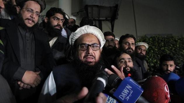 File photo of Hafiz Saeed, chief of the Jamaat-ud-Dawa, speaking with media as he is escorted to his home to be placed under house arrest in Lahore on January 30, 2017.(Reuters)
