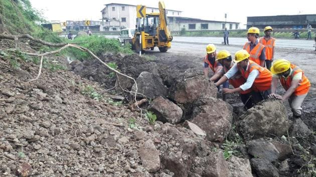 Workers from the Public Works Department (PWD) clear the rubble from the landslide, which took place near Rehamania Hospital in Thane (Praful Gangurde) Workers from the Public Works Department (PWD) clear the rubble from the landslide, which took place near Rehamania Hospital in Thane (Praful Gangurde)