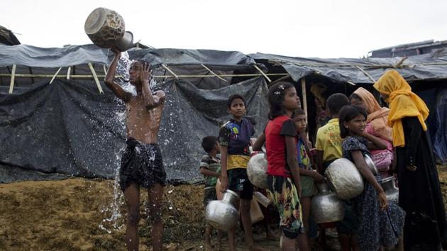 Newly arrived Rohingya wait to collect water from a tube well that was installed a few days ago, as a boy bathes beside them, at Ukhia, Bangladesh, Saturday, Sept. 9, 2017. (AP) Newly arrived Rohingya wait to collect water from a tube well that was installed a few days ago, as a boy bathes beside them, at Ukhia, Bangladesh, Saturday, Sept. 9, 2017. (AP)