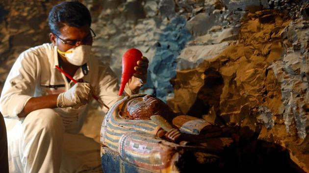 An Egyptian antiquities worker works on a coffin in the recently discovered tomb of Amenemhat, a goldsmith from the New Kingdom, at the Draa Abu-el Naga necropolis near the Nile city of Luxor, south of Cairo on September 9. (REUTERS) An Egyptian antiquities worker works on a coffin in the recently discovered tomb of Amenemhat, a goldsmith from the New Kingdom, at the Draa Abu-el Naga necropolis near the Nile city of Luxor, south of Cairo on September 9. (REUTERS)