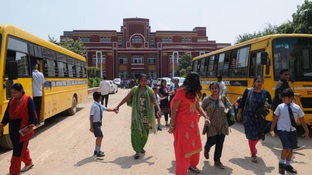 Parents take their children home after the murder of a second grader at Ryan International School in Gurgaon on Friday.(Parveen Kumar/HT Photo)