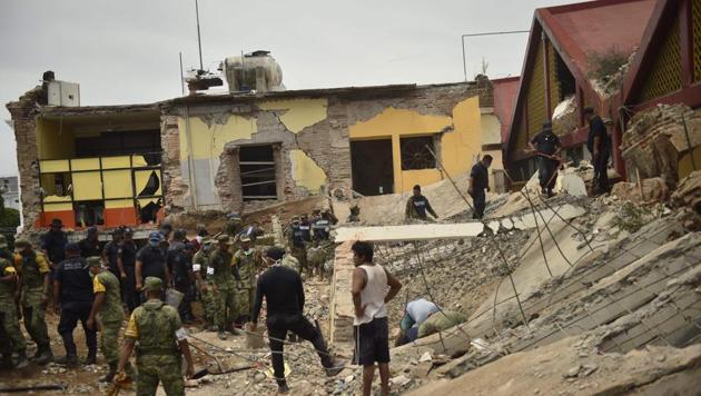 Police officers and members of the Armed Forces work amid the debris of the Town Hall building in Juchitan de Zaragoza, State of Oaxaca, which partially collapsed following an 8.2 earthquake that hit Mexico's Pacific coast overnight on Thursday. (AFP) Police officers and members of the Armed Forces work amid the debris of the Town Hall building in Juchitan de Zaragoza, State of Oaxaca, which partially collapsed following an 8.2 earthquake that hit Mexico's Pacific coast overnight on Thursday. (AFP)