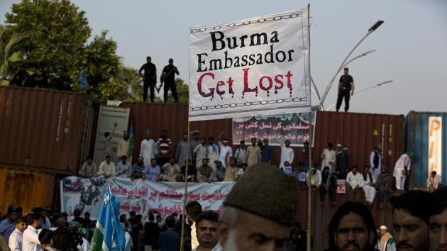 Pakistani protesters stand on shipping containers, authorities put to barred them from marching to the Myanmar Embassy during a protest to condemn the violence against the Rohingya Muslim in Myanmar, in Islamabad on September 8.(AP Photo) Pakistani protesters stand on shipping containers, authorities put to barred them from marching to the Myanmar Embassy during a protest to condemn the violence against the Rohingya Muslim in Myanmar, in Islamabad on September 8.(AP Photo)