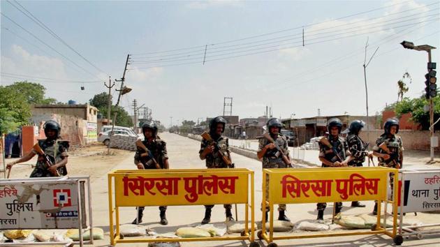 Security forces stand guard at the main entrance to the Dera Sacha Sauda headquarters, in Sirsa district of Haryana on Friday, ahead of the search operations inside the premises. (PTI) Security forces stand guard at the main entrance to the Dera Sacha Sauda headquarters, in Sirsa district of Haryana on Friday, ahead of the search operations inside the premises. (PTI)