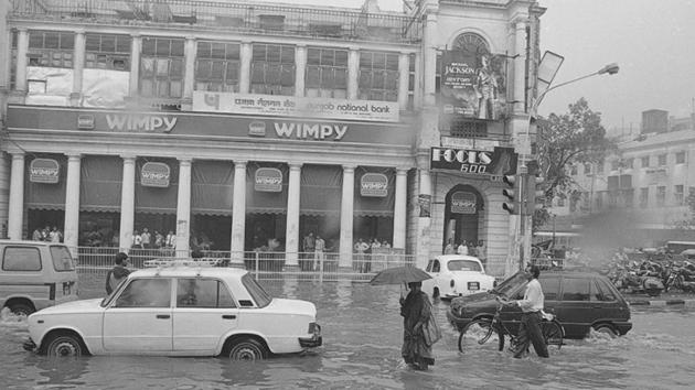 Connaught Place battling the rains in 1995. This year, the Safdarjung observatory recorded around 6.6mm of rain until Thursday morning, while Ayanagar and Ridge areas registered a fair amount of rainfall. (SN Sinha / HT Photo) Connaught Place battling the rains in 1995. This year, the Safdarjung observatory recorded around 6.6mm of rain until Thursday morning, while Ayanagar and Ridge areas registered a fair amount of rainfall. (SN Sinha / HT Photo)