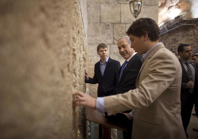 Israeli Prime Minister Benjamin Netanyahu (centre) prays with his sons Yair (background) and Avner (right) at the Western Wall — the holiest site where Jews can pray — in Jerusalem's Old City on January 22, 2013. (AP) Israeli Prime Minister Benjamin Netanyahu (centre) prays with his sons Yair (background) and Avner (right) at the Western Wall — the holiest site where Jews can pray — in Jerusalem's Old City on January 22, 2013. (AP)