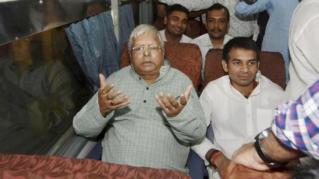 RJD chief Lalu Prasad with his son and leader of opposition Tej Pratap Yadav inside a train at Patna on Saturday. (PTI) RJD chief Lalu Prasad with his son and leader of opposition Tej Pratap Yadav inside a train at Patna on Saturday. (PTI)