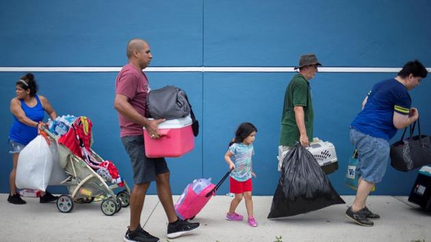 Residents carry their belongings into a shelter ahead of the downfall of Hurricane Irma in Estero, Florida.(Reuters Photo)