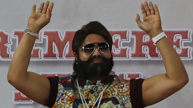 In this file photo, Gurmeet Ram Rahim Singh gestures during the premiere of a movie in New Delhi.(AP)