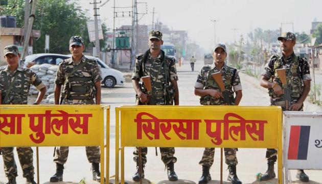 Security forces personnel stand guard during the third day of search operation at the Dera Sacha Sauda ashram in Sirsa on Sunday. (PTI Photo) Security forces personnel stand guard during the third day of search operation at the Dera Sacha Sauda ashram in Sirsa on Sunday. (PTI Photo)