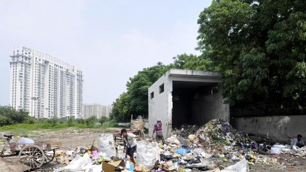 A primary collection centre has already been constructed but mounds of garbage continue to be littered outside it. (Sunil Ghosh/HT Photo) A primary collection centre has already been constructed but mounds of garbage continue to be littered outside it. (Sunil Ghosh/HT Photo)