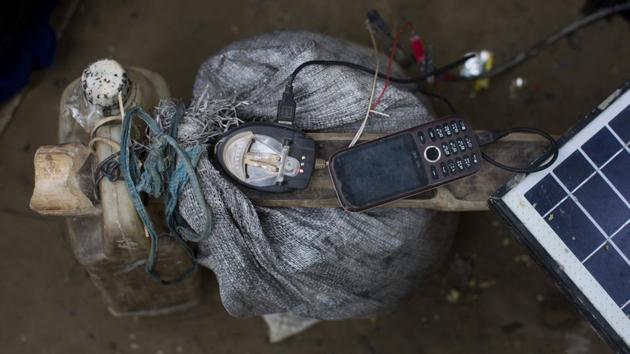 A mobile phone is charged by a solar panel brought across the border by a Rohingya in Teknaf area, Bangladesh. Tied in plastic pouches and hung around their necks, or tucked into the waistbands of their wraparounds, cellphones allow Rohingya to reach relatives who arrived in Bangladesh during earlier waves of fear-fueled migrations from Myanmar. They also allow them to reconnect with relatives they became separated from along the tricky journeys that bring them to safety. (Bernat Armangue / AP) A mobile phone is charged by a solar panel brought across the border by a Rohingya in Teknaf area, Bangladesh. Tied in plastic pouches and hung around their necks, or tucked into the waistbands of their wraparounds, cellphones allow Rohingya to reach relatives who arrived in Bangladesh during earlier waves of fear-fueled migrations from Myanmar. They also allow them to reconnect with relatives they became separated from along the tricky journeys that bring them to safety. (Bernat Armangue / AP)