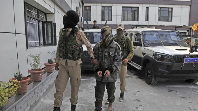 Hizbul Mujahideen militant Adil Hussain is taken by a security personnel to be presented before the media by police in a joint press conference with the Army and the CRPF in Srinagar on Monday. Adil was arrested while two other militant were killed in the encounter at Barbugh area of Shopian. (Waseem Andrabi /HT PHOTO) Hizbul Mujahideen militant Adil Hussain is taken by a security personnel to be presented before the media by police in a joint press conference with the Army and the CRPF in Srinagar on Monday. Adil was arrested while two other militant were killed in the encounter at Barbugh area of Shopian. (Waseem Andrabi /HT PHOTO)