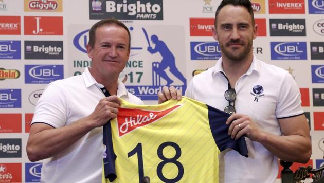 World XI coach Andy Flower displays a match shirt with World XI skipper Faf du Plessis during a news conference in Lahore, Pakistan on Monday. (AP) World XI coach Andy Flower displays a match shirt with World XI skipper Faf du Plessis during a news conference in Lahore, Pakistan on Monday. (AP)