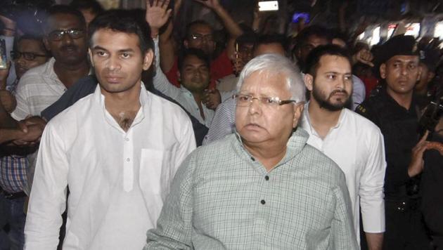 RJD chief Lalu Prasad with his son and leader of opposition Tejashwi Yadav on the way Bhagalpur, in Patna on Saturday.(PTI FILE)
