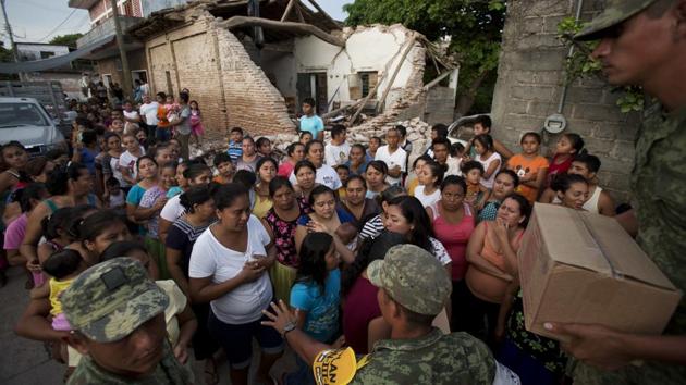Soldiers try to organize a crowd as they hand out rations to people in a zone heavily affected by in Juchitan, Oaxaca state, Mexico. The boxes contained a mix of common Mexican household dried goods, including beans, corn flour, rice, powdered milk, tuna, hot chocolate, and either jalapeno peppers or spicy sauce. (Rebecca Blackwell / AP) Soldiers try to organize a crowd as they hand out rations to people in a zone heavily affected by in Juchitan, Oaxaca state, Mexico. The boxes contained a mix of common Mexican household dried goods, including beans, corn flour, rice, powdered milk, tuna, hot chocolate, and either jalapeno peppers or spicy sauce. (Rebecca Blackwell / AP)