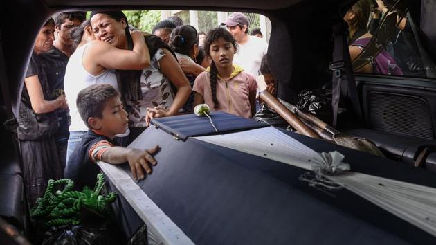 Relatives of late policeman Juan Jimenez mourn him during a funeral of victims of the 8.1-magnitude earthquake that hit Mexico's Pacific coast, in Juchitan de Zaragoza, Mexico on September 10, 2017. Sobbing Mexican families followed coffins through the streets and picked nervously at the ruins of their homes Sunday as help trickled in after the huge earthquake killed 91 people. (Victoria Razo / AFP) Relatives of late policeman Juan Jimenez mourn him during a funeral of victims of the 8.1-magnitude earthquake that hit Mexico's Pacific coast, in Juchitan de Zaragoza, Mexico on September 10, 2017. Sobbing Mexican families followed coffins through the streets and picked nervously at the ruins of their homes Sunday as help trickled in after the huge earthquake killed 91 people. (Victoria Razo / AFP)
