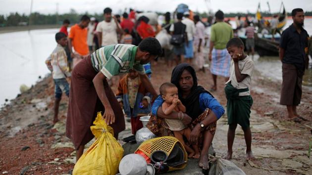 Rohingya refugees sit near a jetty after crossing the Bangladesh-Myanmar border by boat through the Bay of Bengal in Shah Porir Dwip, Bangladesh, on September 10, 2017. (Reuters) Rohingya refugees sit near a jetty after crossing the Bangladesh-Myanmar border by boat through the Bay of Bengal in Shah Porir Dwip, Bangladesh, on September 10, 2017. (Reuters)