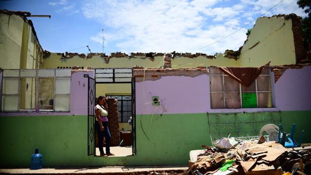A woman stands at the door of her partially collapsed house as she prepares to evacuate it, in Tonala, Chiapas State, Mexico. Thursday’s quake was bigger even than the 8.1 quake that killed 10,000 people in Mexico City in 1985 and the biggest in 100 years according to President Enrique Pena Nieto who declared three days of national mourning and pledged to rebuild shattered towns and villages. (Ronaldo Schemidt / AFP) A woman stands at the door of her partially collapsed house as she prepares to evacuate it, in Tonala, Chiapas State, Mexico. Thursday’s quake was bigger even than the 8.1 quake that killed 10,000 people in Mexico City in 1985 and the biggest in 100 years according to President Enrique Pena Nieto who declared three days of national mourning and pledged to rebuild shattered towns and villages. (Ronaldo Schemidt / AFP)