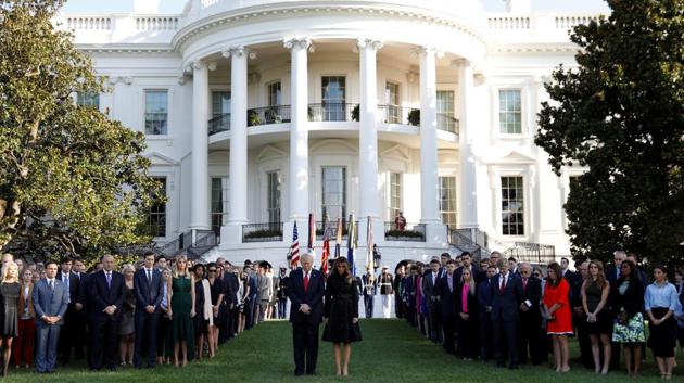 US President Donald Trump and first lady Melania Trump observe a moment of silence in remembrance of those lost in the 9/11 attacks at the White House in Washington.(REUTERS)