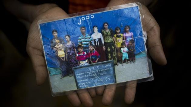 Mubarak Begum, holds a photograph of her family members, in Bangladesh. She says the government took pictures of Rohingya families annually to track numbers. Her daughter Rubina (face scratched) couldn't make it across and is still in Maungdaw. An estimated 300,000 Rohingya have fled in the fortnight since August 25, 2017. As thousands pour into Bangladesh escaping shootings, arson, violence and growing reports of landmines along the border, most carry but a handful from life back home. (Bernat Armangue / AP) Mubarak Begum, holds a photograph of her family members, in Bangladesh. She says the government took pictures of Rohingya families annually to track numbers. Her daughter Rubina (face scratched) couldn't make it across and is still in Maungdaw. An estimated 300,000 Rohingya have fled in the fortnight since August 25, 2017. As thousands pour into Bangladesh escaping shootings, arson, violence and growing reports of landmines along the border, most carry but a handful from life back home. (Bernat Armangue / AP)