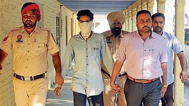 The accused in police custody in Jalandhar on Monday.(Pardeep Pandit/HT)